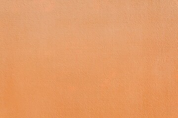 A plain, solid-colored background with a uniform shade of light orange