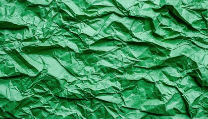 Fototapeta premium A close-up of crumpled green paper, showcasing texture and depth, suitable for backgrounds or creative projects.