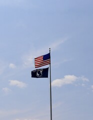 The waving American flag with a blue sky background.