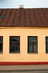 brown windows in a yellow house