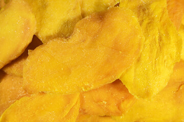 Healthy dried mango chips without added sugar close up full frame as background