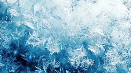 Intricate ice crystals form a stunning, frosty pattern on a window pane.