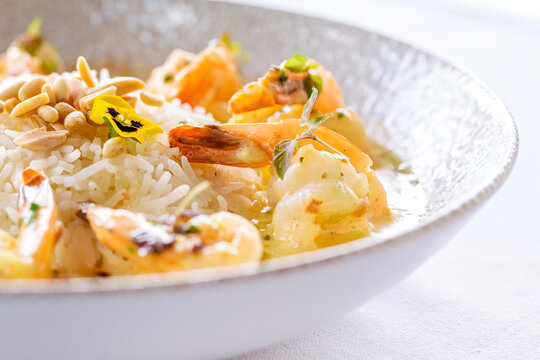 Creamy garlic prawns served in a white bowl.