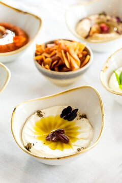 Labneh served in a small bowl on a white countertop.