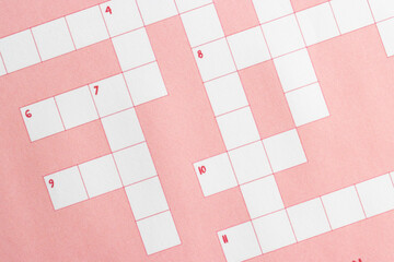 Empty, unfinished crossword puzzle with pink background. 