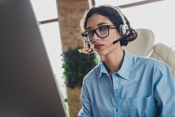 Photo of cheerful positive lady recruiter dressed shirt glasses headphones texting modern device indoors workplace workstation loft