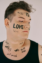 A queer person showcases powerful messages of love and unity through body art.