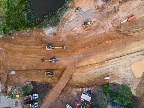 Aerial view of three earthmoving machinery on construction site for Singleton Bypass