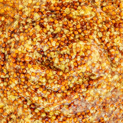 Mustard sauce grained texture. Yellow Traditional French Mustard sauce as a background. Texture of Dijon mustard. Pattern
