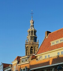 Fototapeta premium City view of Gouda in the Netherlands, with a church and some buildings in the foreground. 