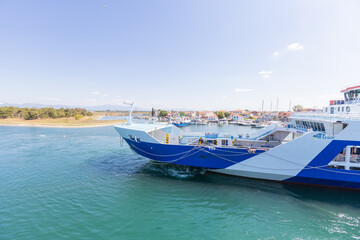 Fototapeta premium Ferry Arriving at Keramoti Harbor, Greece on a Sunny Day