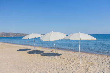 Sunny Beach Scene with White Umbrellas - Summer Vacation