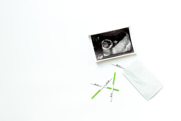 Ovulation and pregnancy tests with Ultrasound image of a baby. Pregnancy and conceiving a child...
