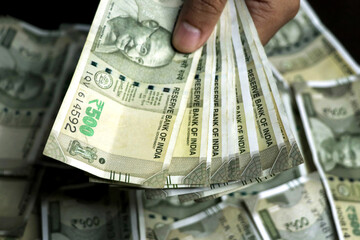A man hand holding Indian 500 Rupees bank note