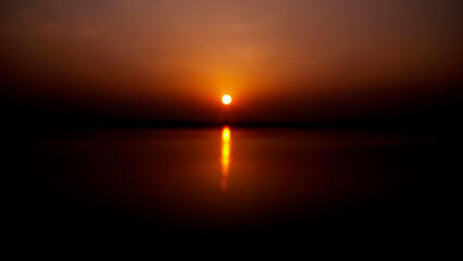 the sun setting over the water