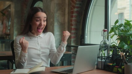 Happy joyful excited winner Caucasian woman girl lady businesswoman winning victory triumph achieve business success scream shout female student accomplish online exam good result on laptop in office
