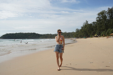 A young woman enjoying a beautiful day at the beach 