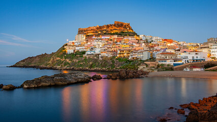 Picturesque panoramic view of the medieval town of Castelsardo at the beginning of the blue hour, Province of Sassari, Sardinia, Italy, Europe.
