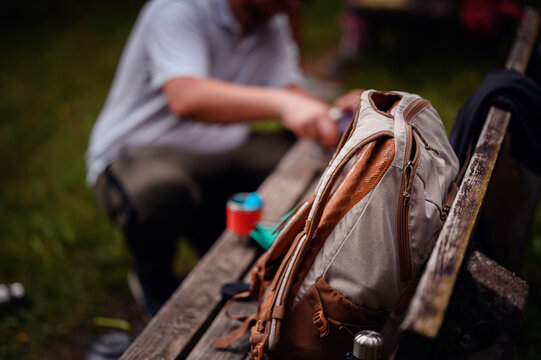 Backpack on Bench with Camper in Background Preparing Gear