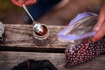 Adding Coffee Grounds to Moka Pot for Outdoor Brewing