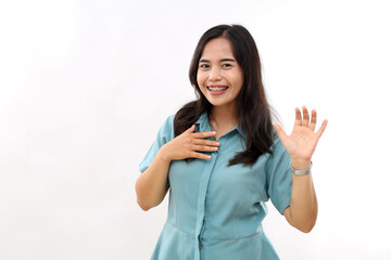 Fototapeta premium Happy dark haired pretty Asian woman with positive expression laughs joyfully keeps hand raised smiles broadly wears casual shirt earrings hears something funny isolated over white background.
