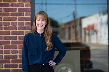 Woman posing outside of a restaurant