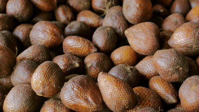 Closeup of Piled Salak Salacca zalacca Fruit at a Tropical Fruit Stall, Highlighting Its Unique Sweet and Astringent Flavor.