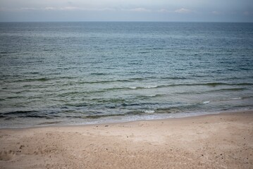 The coastline of the Baltic Sea in northern Poland features stunning sandy beaches, picturesque dunes, and lush greenery, offering a serene escape for nature lovers and beachgoers.