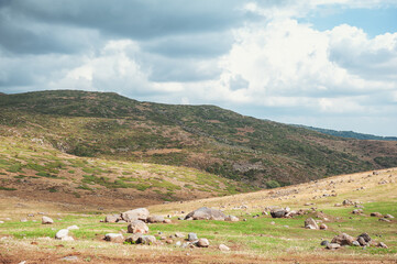 Dramatic mountain valley under a cloudy sky with a rugged landscape