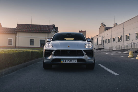 SUV Porsche Macan on the background of the sunset. Kyiv, Ukraine - September 2024.