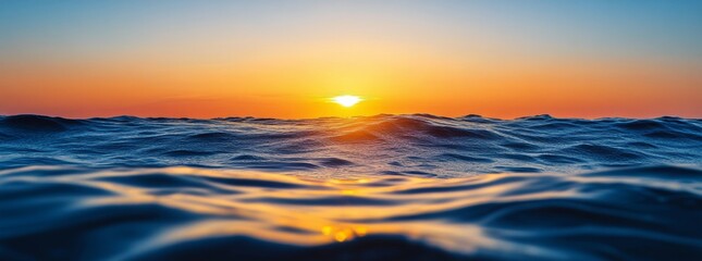 Obraz premium Beautiful sunset over the ocean showcasing vibrant colors and calming waves in the evening