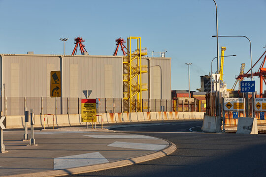 a street view of the port with cargo containers and cranes