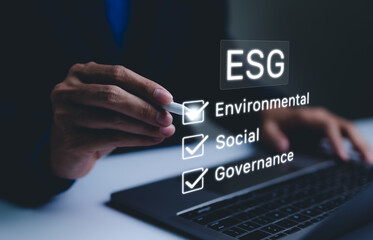 ESG Concept for Environmental, Social, and Governance. Businessman checking off ESG factors Environmental, Social, Governance on virtual screen, sustainable business practices. strategy investing, CSR