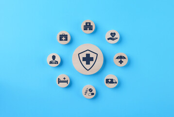 Health insurance and medical care concept. A set of wooden blocks displaying health-related icons, medical care, health insurance, and medication. healthcare services, protection, insurance coverage,