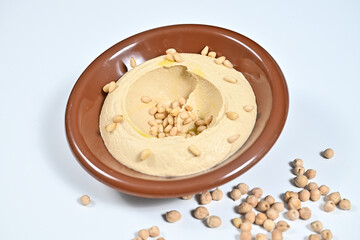 Bowl of hummus topped with peanut chips