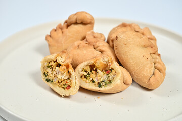 Tortilla rollups on a white plate with creamy sauce