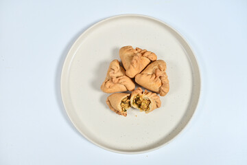 Tortilla rollups on a white plate with creamy sauce