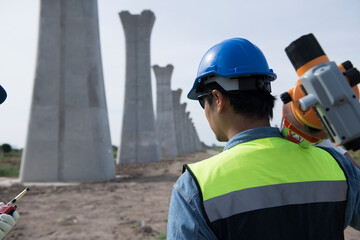 Surveyors working at new construction site. construction worker on a site. Surveyor engineers using an Leveling camera at Construction Site.