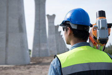 Obraz premium Surveyors working at new construction site. construction worker on a site. Surveyor engineers using an Leveling camera at Construction Site.