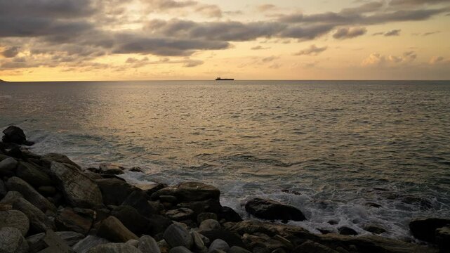 Time lapse of waves breaking on the rocks on a tropical beach at sunset. Macuto Coast, Venezuela.