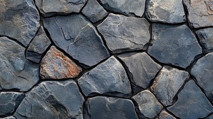 Fototapeta premium A stone wall composed of large, rectangular stones.