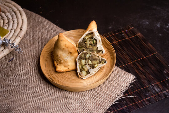 Liver ingara or Kolija singara served in plate isolated on dark background side view of bangladeshi fast food