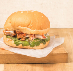 Burger with lettuce and Chicken on a background.
