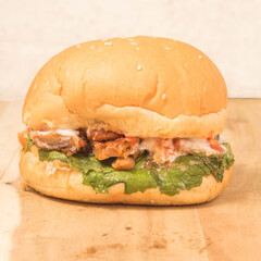 Burger with lettuce and Chicken on a background.
