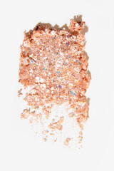Smear of shimmery eyeshadow with glitter on a light white background. Beauty product, radiant texture.