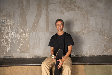 54 year old Brazilian skateboarder in a photo shoot at a skate park_1.