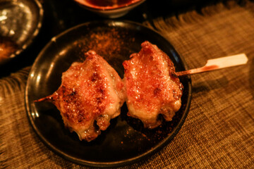 close of two pieces of Japanese grilled chicken wings 