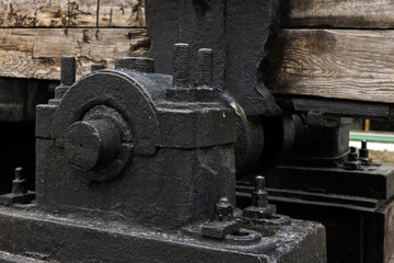 Massive parts of vintage black industrial machine, close up
