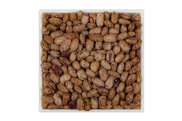 Raw pinto beans (Phaseolus coccineus), Spanish legume in an eco-friendly white square bowl on a white background