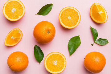 Fruit pattern of fresh orange slices on colored background. Top view. Copy Space. creative summer concept. Half of citrus in minimal flat lay
